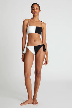 Slip bikini bicolore nero con fiocco